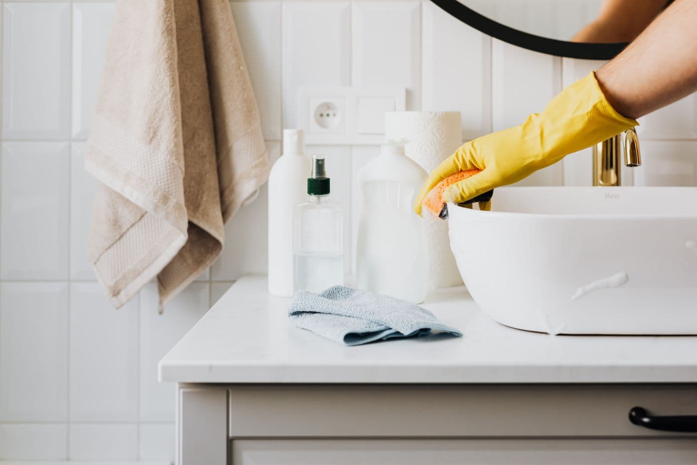 Detailed bathroom sink scrubbing with professional cleaning supplies