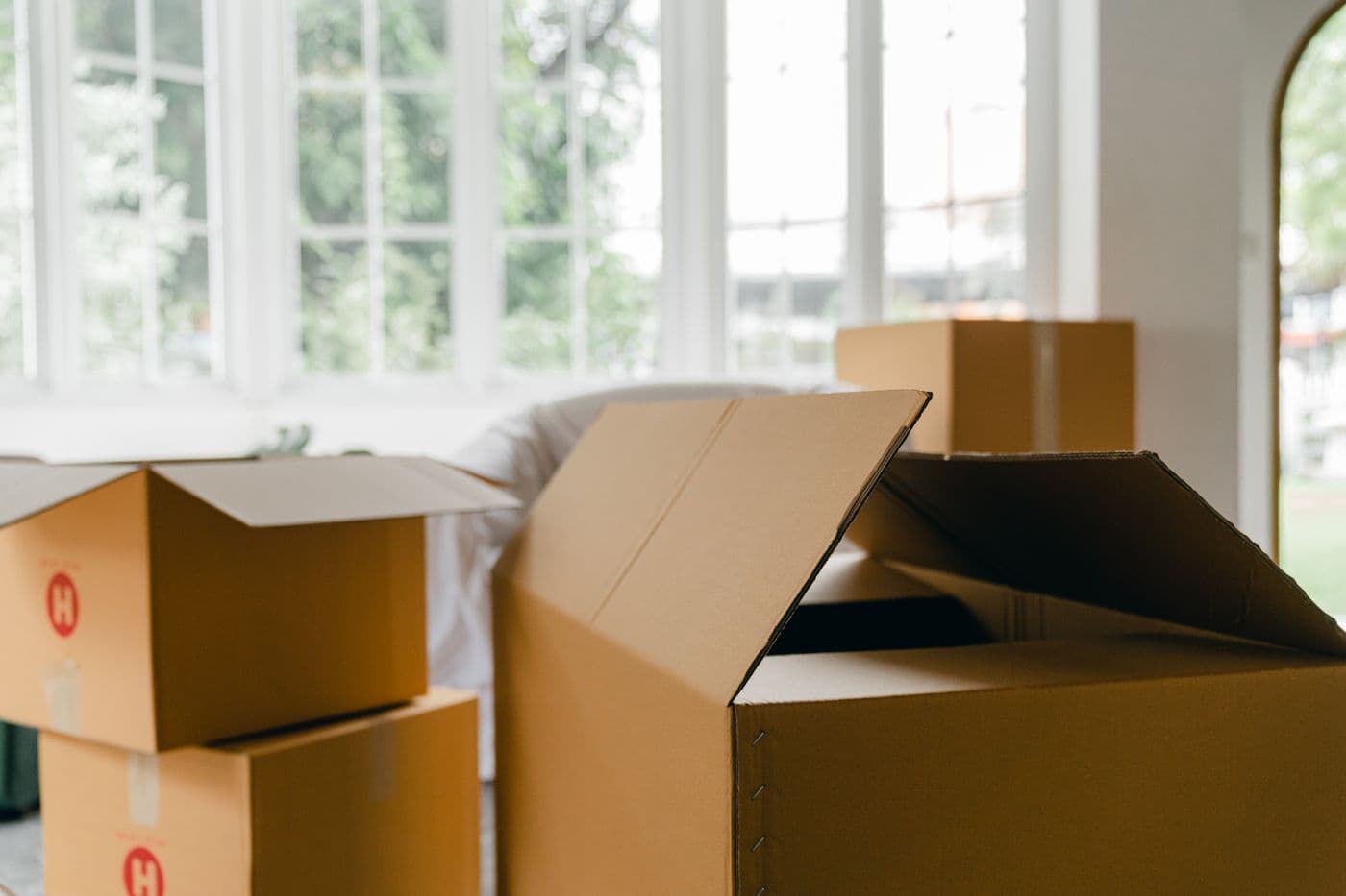 Moving boxes in a bright room ready for move-in or move-out cleaning